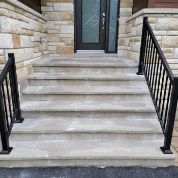 alt="Outdoor concrete stairs worn by freeze-thaw cycles."