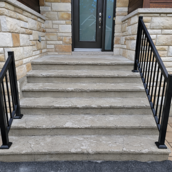alt="Damaged outdoor concrete steps in front of a home."