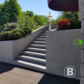 alt="Outdoor stairs with textured grey coating."