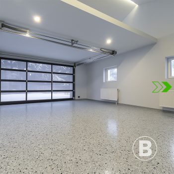 alt="Bright garage with grey flake floor coating."