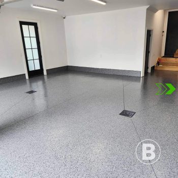 alt="Garage with grey flake floor coating."