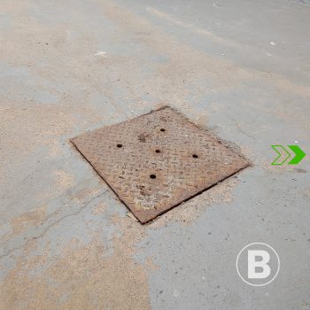 alt="Worn concrete slab with stains and dust."